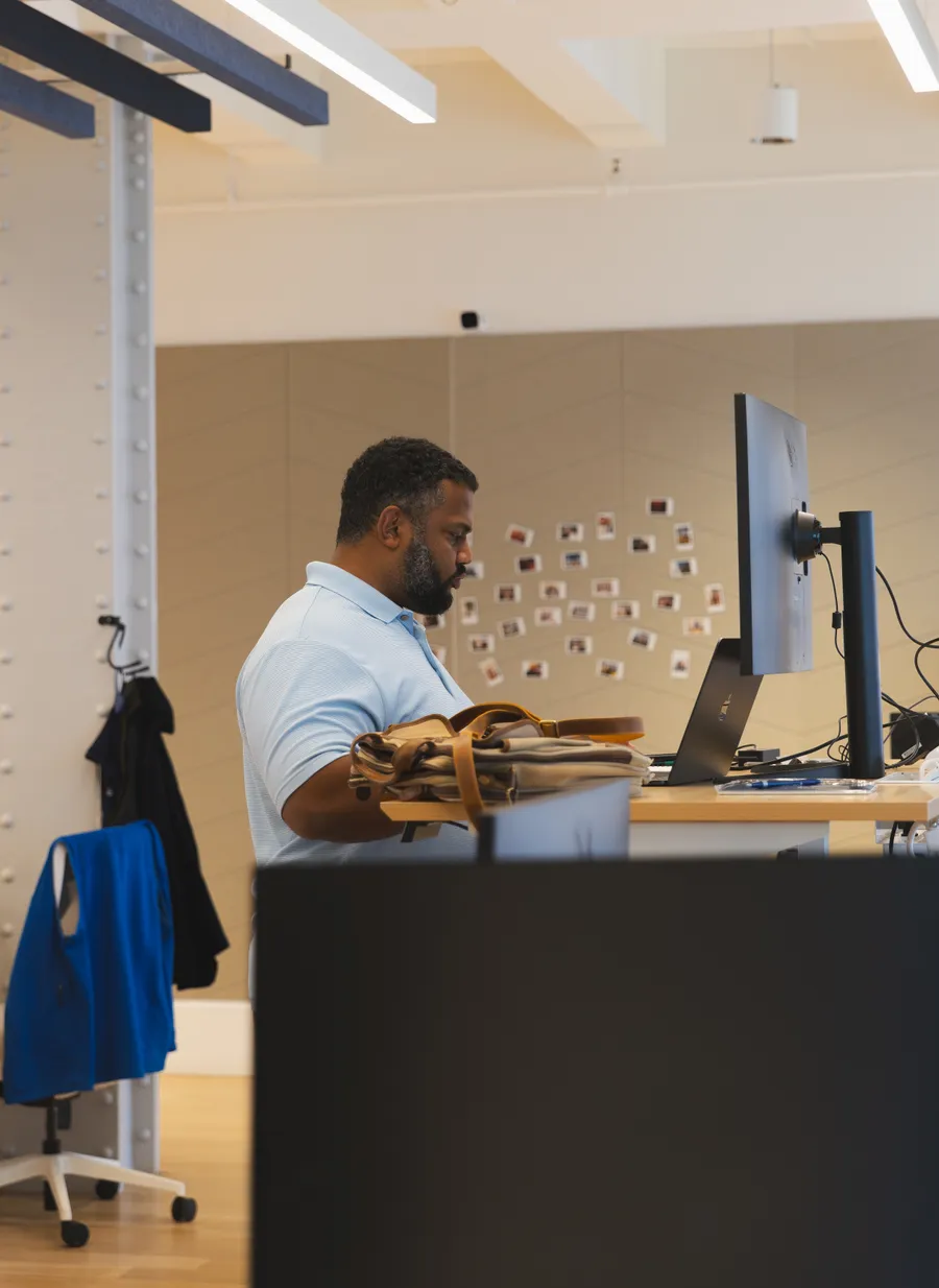 Team member working at a standing desk