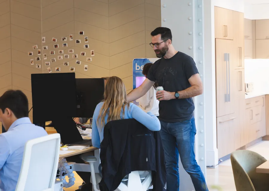Colleagues chatting near the kitchen